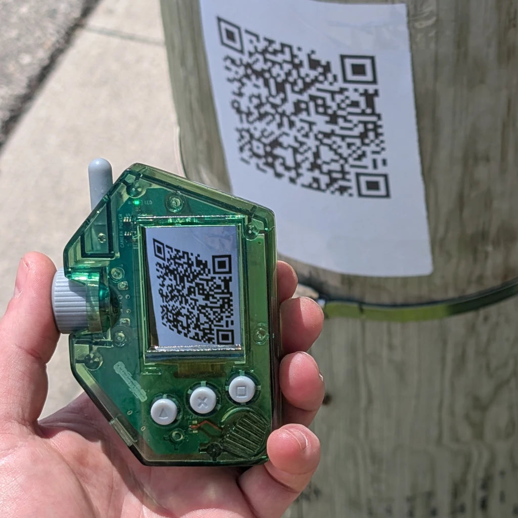 Quzu Scanner handheld toy scanning a real-world QR code outdoors