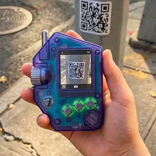 Quzu Scanner handheld toy scanning a real-world QR code outdoors